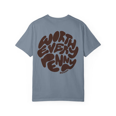Dusty blue t-shirt by @ensowax with a circular brown graphic on the back displaying "WORTH EVERY PENNY" in a bold bubbly font