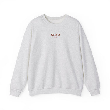 Enso brand light grey heathered crewneck sweatshirt featuring enso EST 22 in brown lettering on the chest with ribbed cuffs and hem