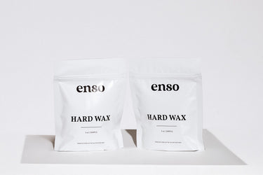 Product photograph featuring two identical white enso HARD WAX sample pouches with black lettering and subtle shadows on a minimalist white background