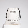 A beige drawstring bag featuring the black enso logo and HARD WAX text with 10 LBS | 4.5 KG weight details displayed on a white studio pedestal